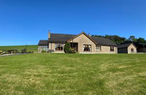 a large house with a large lawn in front of it at Hill Farm in Dunmore