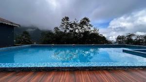 a large swimming pool on a wooden deck at The Z Retreat & Spa - Swimming Pool & Free Parking - Near Tashi ViewPoint in Gangtok