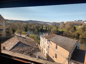 a view of a river from a building at A Casa da Ponte in Lugo +18 photos