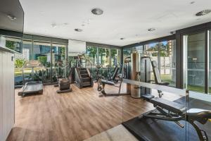a gym with treadmills and elliptical machines at CBD Luxury River View & Fireworks 1Bed Apt The One in Brisbane