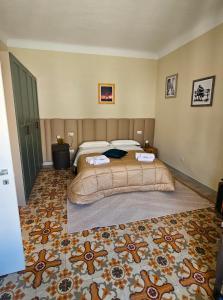 a bedroom with a large bed and a carpet at Da Me & Te in Ginosa