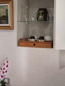 a shelf on a wall with some items on it at Passage des Romains studio in Horbourg +20 photos