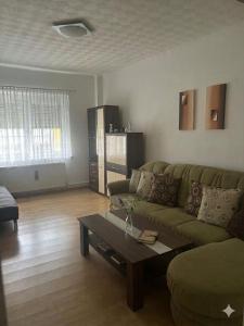 a living room with a couch and a coffee table at Stratos Apartments in Laa an der Thaya