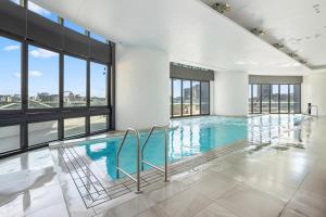 a swimming pool with a view of a building at CBD Luxury River View & Fireworks 1Bed Apt The One in Brisbane