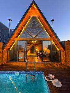 a house with a swimming pool in front of it at Defne Bungalow Yomra in Yomra