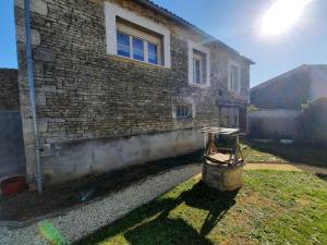 a brick house with a table in front of it at La Grange de Lilou in Aiffres