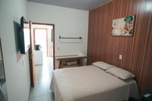 a bedroom with a bed and a desk and a television at Residencial Antônio Floriza in Sinop +12 photos