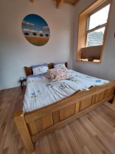 a bedroom with a large bed with a large window at Kamer op de wierde Rottum in Rottum