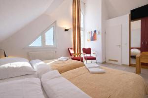 a bedroom with two beds and a table and a chair at Airport Messe Villa Casa in Düsseldorf +37 photos