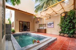 an indoor swimming pool in a house at Linh Lan Homestay in Phan Thiet