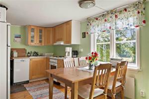 a kitchen with a wooden table and a window at KRO048-Urshult-Vaesterbotorp-Bosgard in Urshult