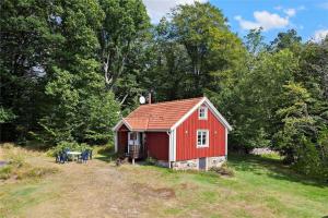 a red barn in a field next to trees at KRO048-Urshult-Vaesterbotorp-Bosgard in Urshult +10 photos