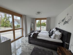 a living room with a couch and a large window at Arenenberg-Panorama in Salenstein