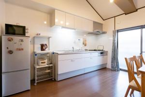 a kitchen with a refrigerator and a sink at 逸泊居 in Osaka +36 photos