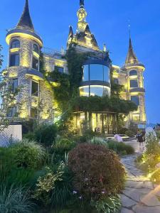 a large house with a tower on top of it at Bay Four Seasons Castle Hotel in Weihai
