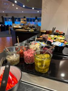 a buffet line with different types of food in bowls at Grong Hotell in Grong +42 photos