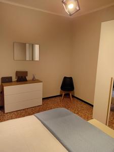 a bedroom with a bed and a desk and a chair at Alloggio Veronica in Voghera