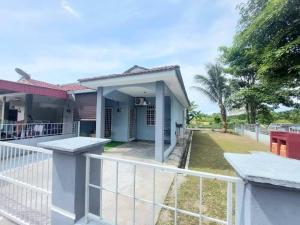 a house with a fence in front of it at Abadi Homestay Ipoh in Ipoh