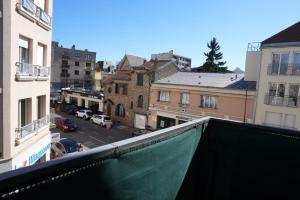 a view of a city street from a balcony at Chez Leela in Poissy