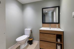 a bathroom with a toilet and a sink and a mirror at Yourte mongole insolite en pleine nature in Pouilly-sous-Charlieu