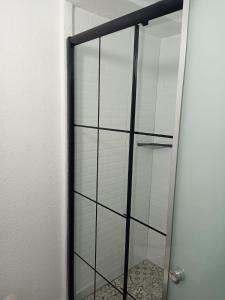 a glass shower door in a bathroom with a tile floor at Kelebek Ayvalık in Ayvalık +40 photos