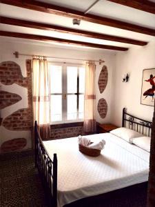 a bedroom with two beds and a window at Kelebek Ayvalık in Ayvalık