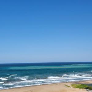 a view of the ocean from a beach at Muscat Beach Hostel in Muscat