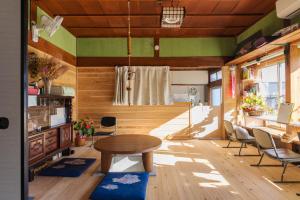 a living room with a table and chairs at 杜の酵素808 in Takaharu