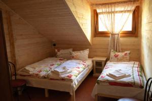 a bedroom with two beds in a wooden cabin at Lacu Roșu Escape Lodge in Lacu Rosu +18 photos