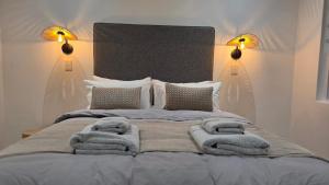 a bedroom with a bed with towels on it at NamibStay Swakop Self Catering in Swakopmund