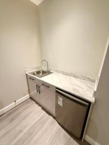 a kitchen with a sink and a counter top at Aire House, Keighley in Keighley