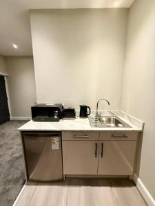 a kitchen with a sink and a counter top at Aire House, Keighley in Keighley +23 photos