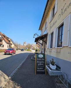 a building with a sign in front of a street at Hotel & Restaurant Krone in Märkt in Weil am Rhein