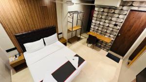 a bedroom with a bed and a stone wall at U LIFE HOTEL in Mumbai