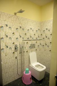 a bathroom with a toilet and a shower at hotel nemi residency jagdalpur in Jagdalpur +16 photos