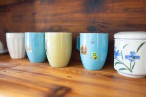 a row of blue and white cups sitting on a table at Casa Brezza Marina in Punta Marina