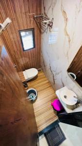 a small bathroom with a toilet and a sink at U LIFE HOTEL in Mumbai