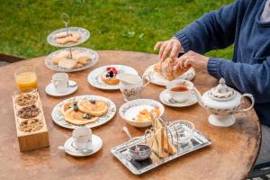 a table with plates of breakfast food on it at Locanda Scotti in Paladina