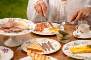a person eating food on a table with plates of food at Locanda Scotti in Paladina +57 photos