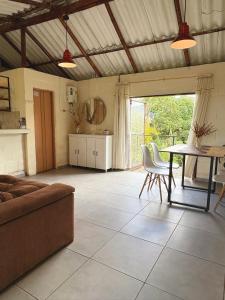 a living room with a couch and a table at La Morada Quindio cabaña campestre in Boquía +19 photos