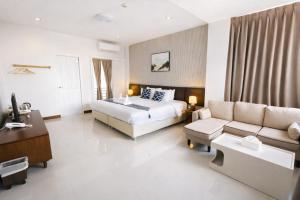 a hotel room with a bed and a couch at Chiang Mai Waroros Boutique Hotel in Chiang Mai +30 photos