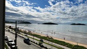 a view of a beach with people on it at Hotel Polonini in Piúma