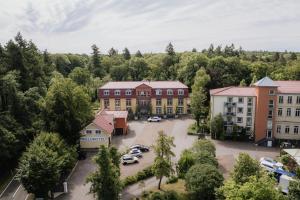 an aerial view of a town with cars parked in a parking lot at Waldhotel Rheinbach in Rheinbach
