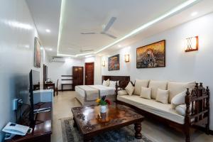 a living room with a couch and a table at PrideInn Hotel Nyali in Mombasa