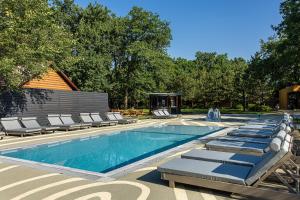 a swimming pool with chaise lounge chairs next to it at Lake Park in Novomoskovsʼk