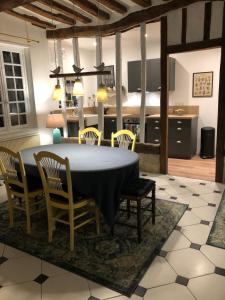 a kitchen and dining room with a table and chairs at La Gruchette in Gruchet-Saint-Siméon