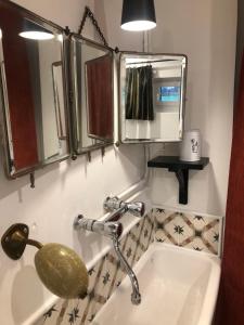 a bathroom with a sink and a mirror at La Gruchette in Gruchet-Saint-Siméon