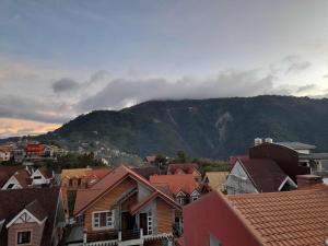 a view of a town with a mountain in the background at MountainFog Transient House 2 in Baguio