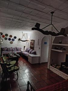 a living room with a couch and a table at Hostel Terra das Tribos in Ubatuba