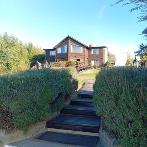 a house with a staircase leading up to a house at Altos de Soberana in El Calafate